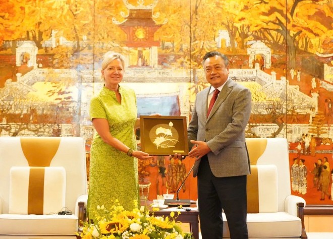 Chủ tịch UBND TP. Hà Nội Trần Sỹ Thanh tặng biểu trưng hoa sen khảm thủ công cho bà Mariam J. Sherman, Giám đốc Quốc gia Ngân hàng Thế giới phụ trách khu vực Việt Nam, Lào và Campuchia. Ảnh: Hoàng Nam