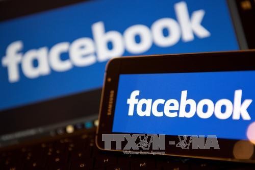 Biểu tượng Facebook trên màn hình điện thoại và máy tính. Ảnh: AFP/TTXVN.