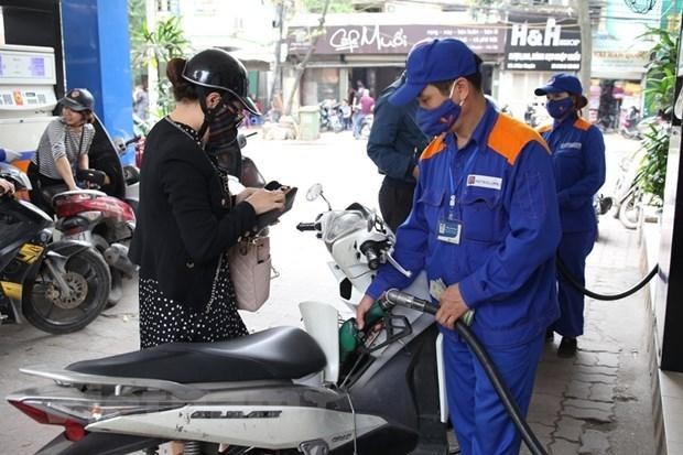 Nhân viên Petrolimex đang bán xăng cho khách hàng. (Ảnh: PV/Vietnam+)