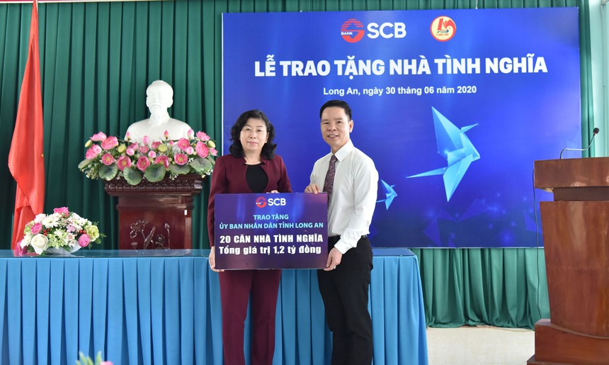 Ông Đinh Văn Thành, Chủ tịch HĐQT SCB trao biểu trưng tài trợ.