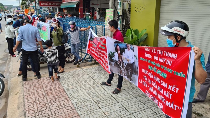 Khách hàng căng băng-rôn tố công ty lừa đảo và đòi lại tiền.