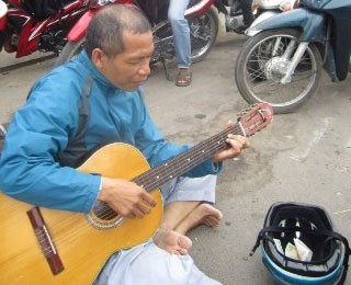 Bức ảnh ông Nguyễn Mạnh Hùng ngồi hát rong được đăng trên Facebook.